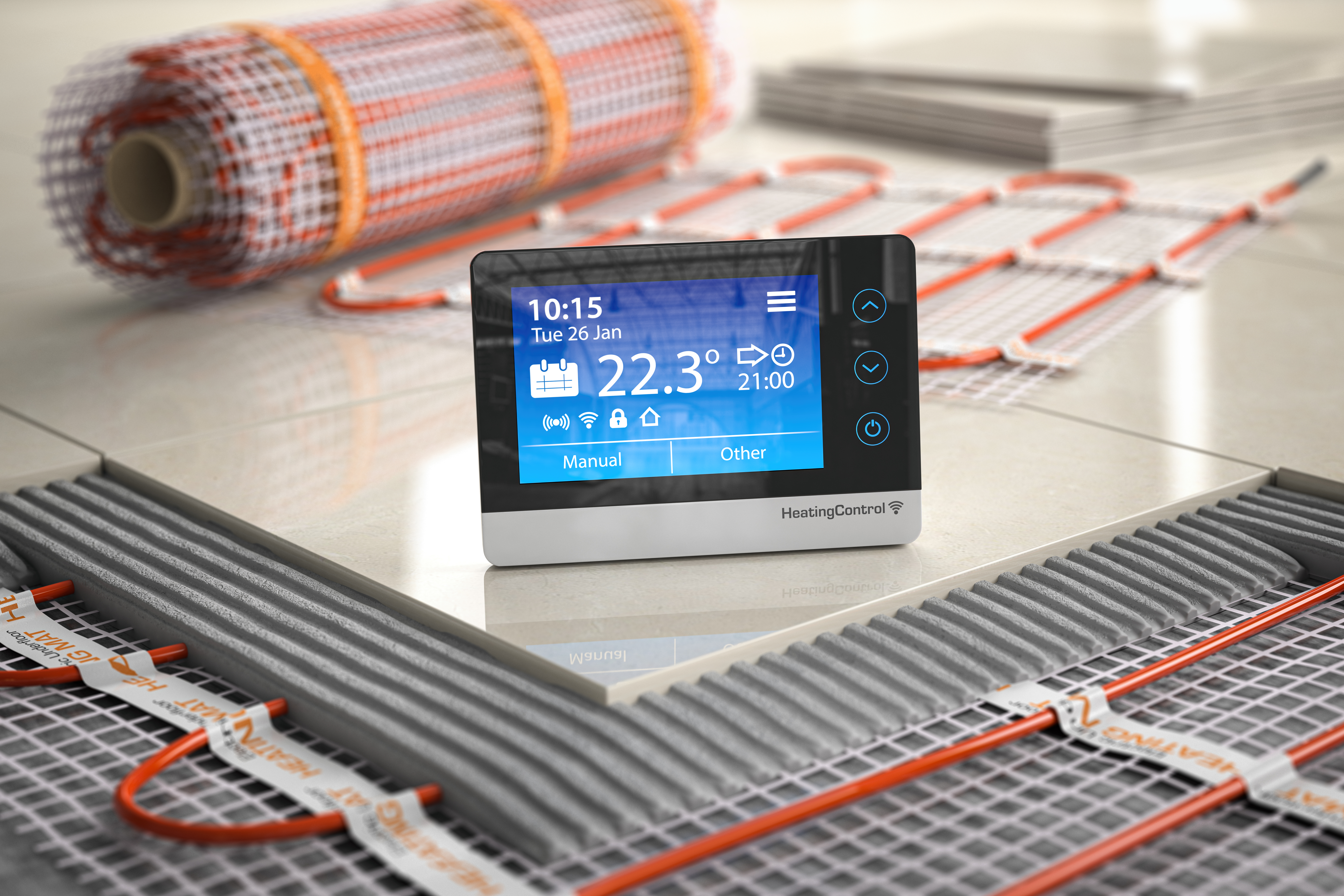 A detailed photograph of an underfloor heating system, showcasing a thermostat or climate control unit, an electric heating mat, and the layers of a floor construction, including ceramic tiles and cement, highlighting the components and installation of the system