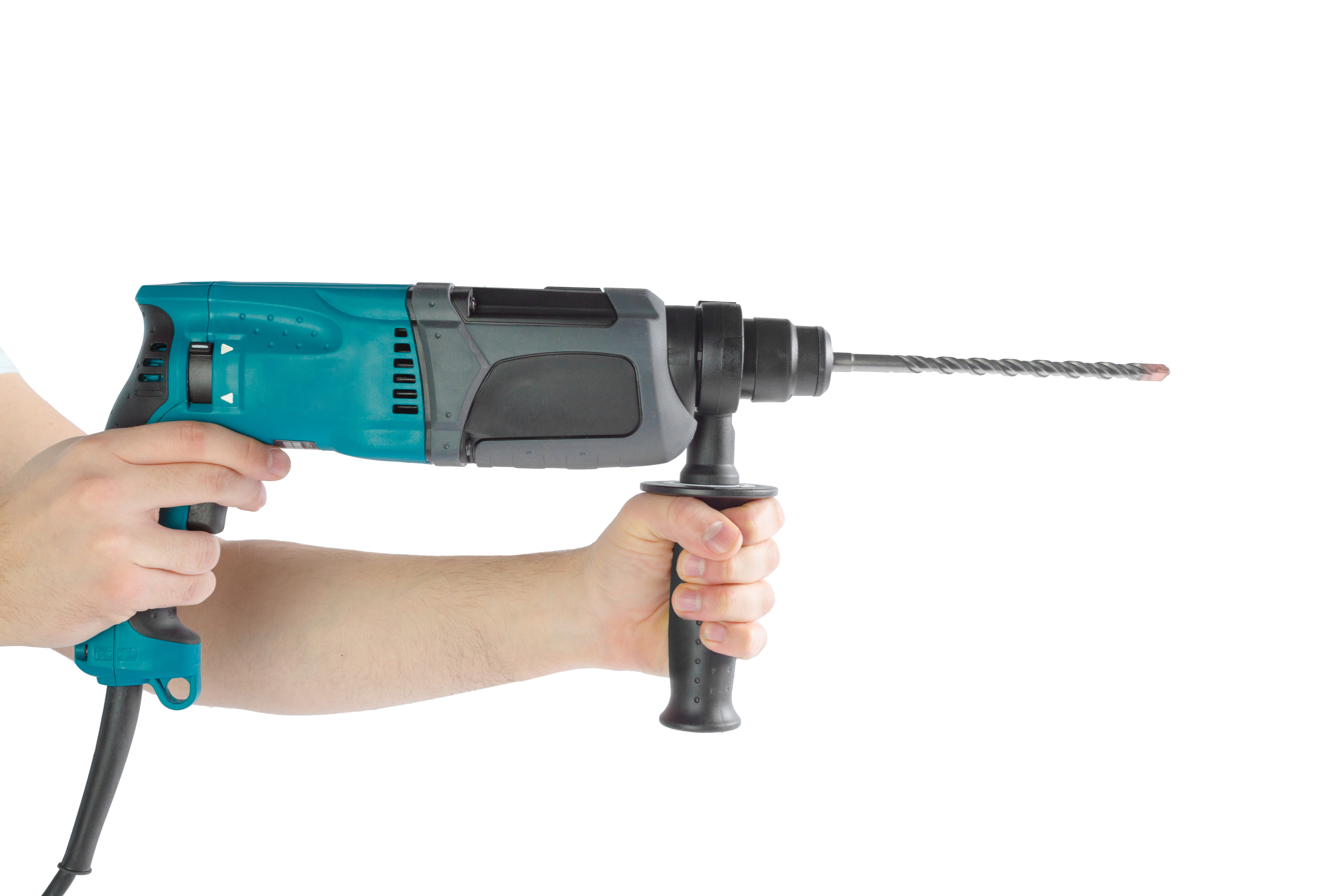 Man using a hammer drill to drill into a wall